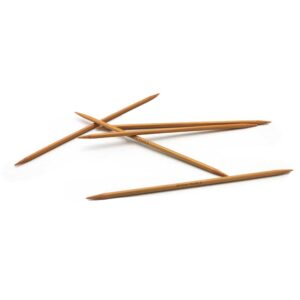 Five 8 inch bamboo double point needles scattered on a white background