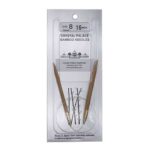 A size 8, 16 inch bamboo circular needle in its silver packaging