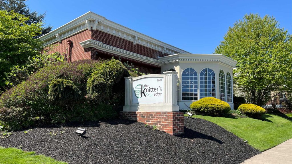 Exterior of The Knitter's Edge store on a bright, sunny day.